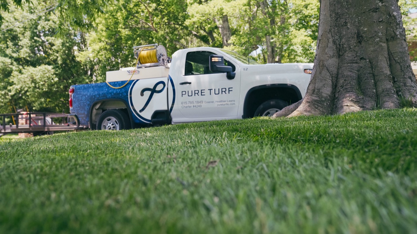 A Pure Turf truck on a healthy green lawn